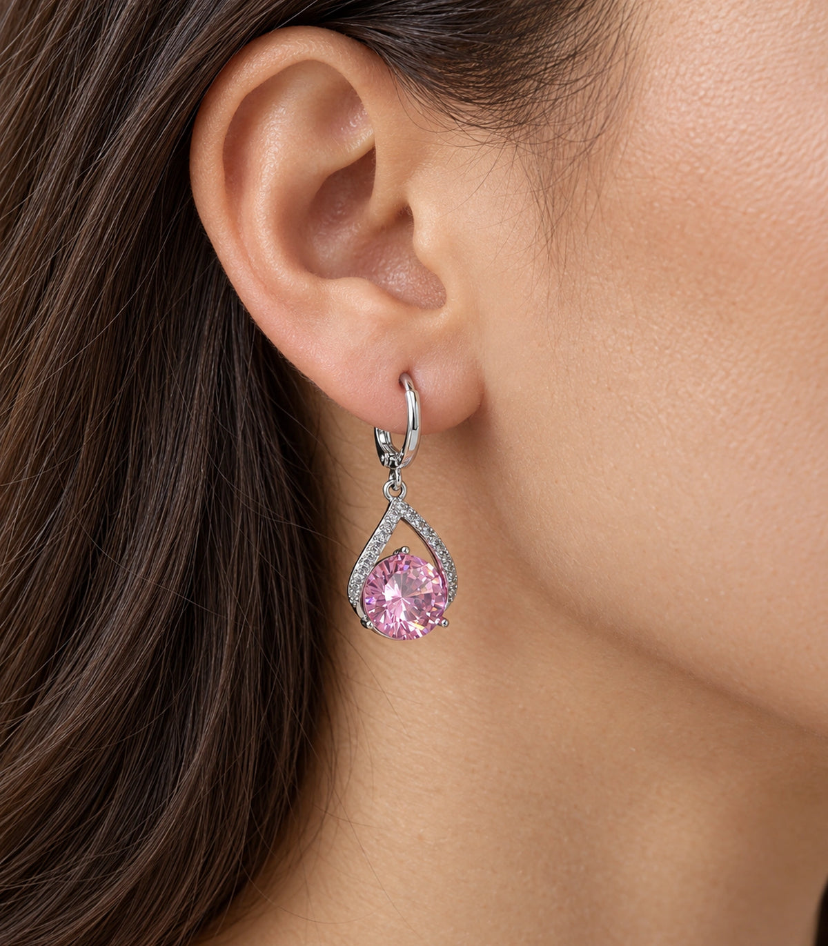 JIMIKI Silver-Tone Pink Crystal Teardrop Huggie Earrings in Silver / Pink, close-up detail