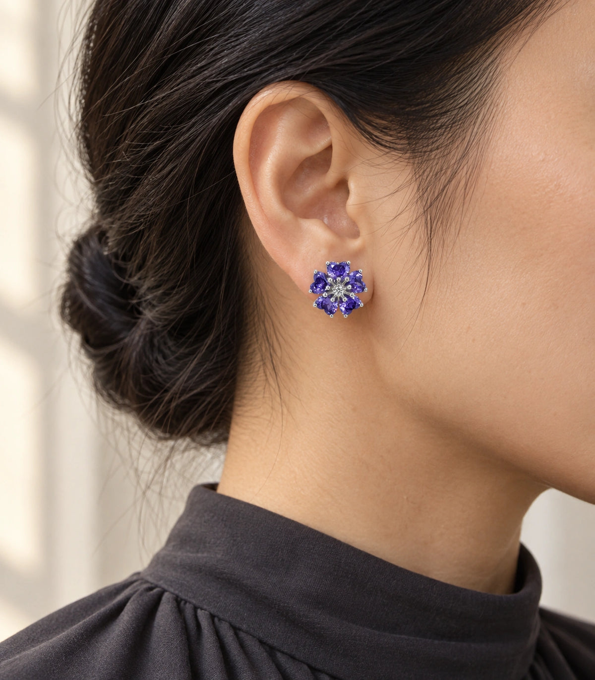 JIMIKI Five Petal Crystal Flower Stud Earring Pair in Silver tone / purple, editorial model view #color_silver tone / purple