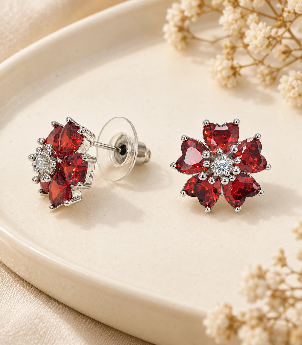 JIMIKI Five Petal Crystal Flower Stud Earring Pair in Silver tone / red, editorial flat lay #color_silver tone / red