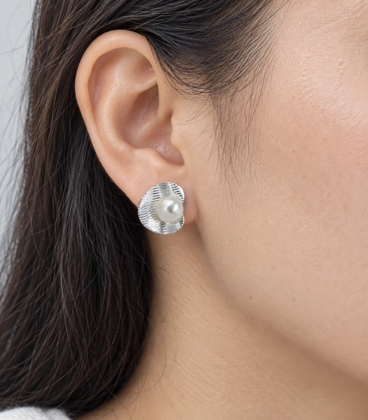 JIMIKI Ribbed Curved Disc Pearl Stud Earring Pair in Silver tone / White, close-up detail #color_silver tone / white
