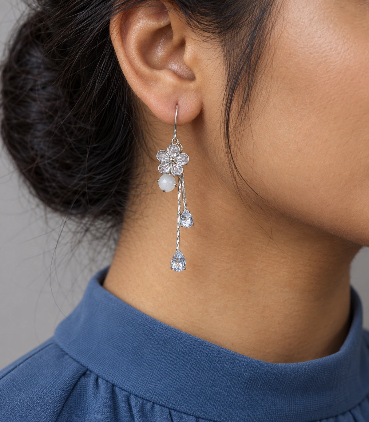 JIMIKI Silver Tone Rounded Flower White Stone Twin Pear Earring Pair in Silver-tone, model wearing view