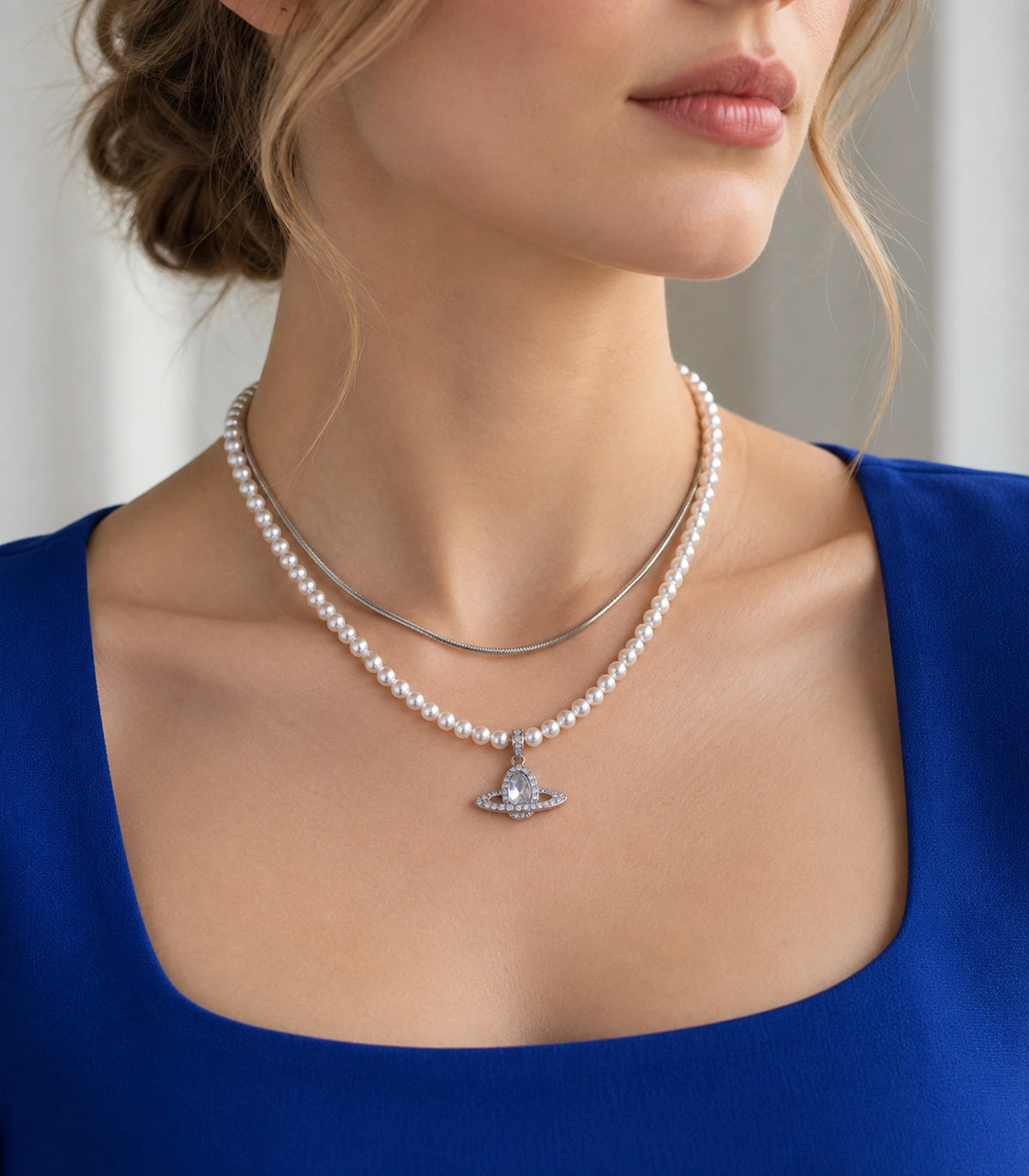 JIMIKI Silver-Tone Saturn Layered Pearl Necklace Set in Silver-tone / clear / white, styled on a model in an editorial setting