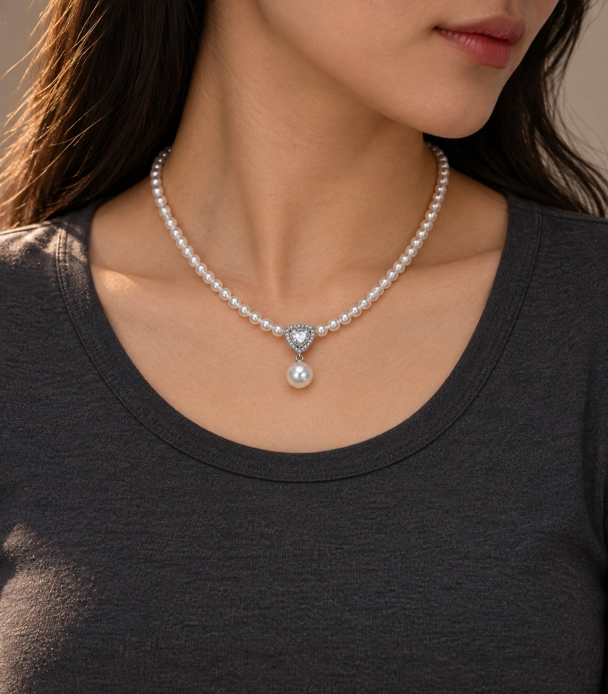 JIMIKI Silver Tone Shield Crystal Pearl Drop Necklace in Silver / White, editorial model view