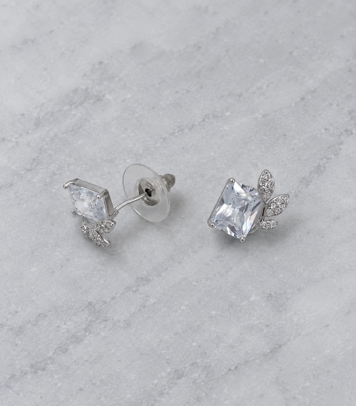 JIMIKI Silver-Tone Square Crystal Three-Leaf Stud Earrings in Silver / Clear, editorial flat lay