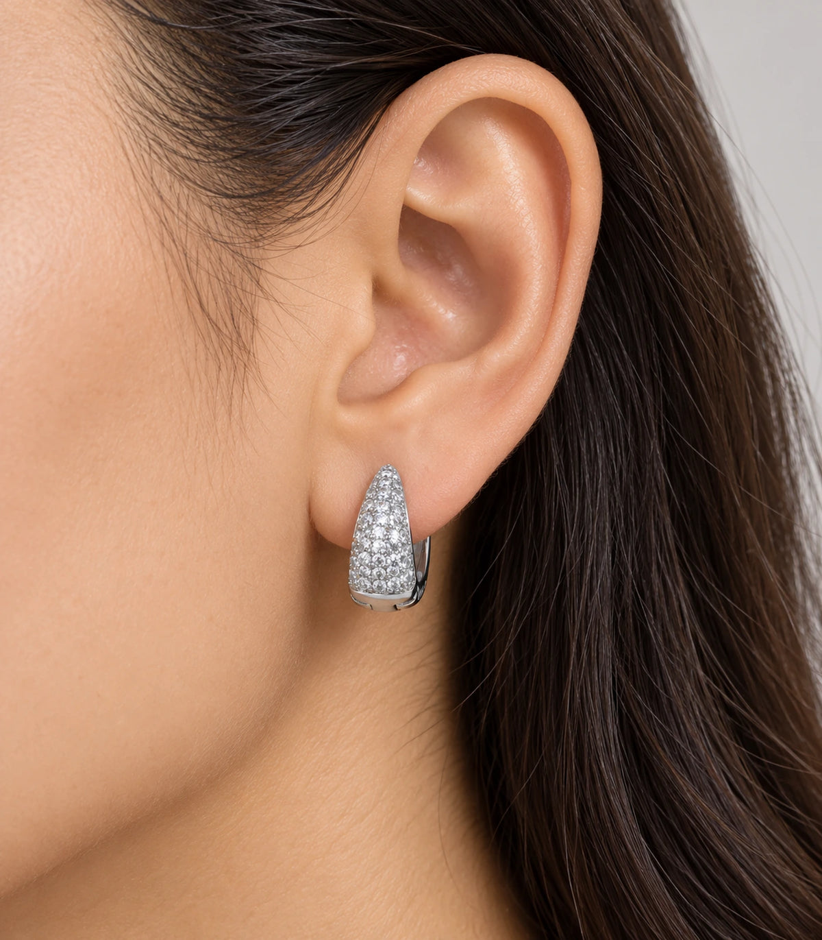 JIMIKI Silver tapered pave huggie hoop earrings, worn on the ear #color_silver