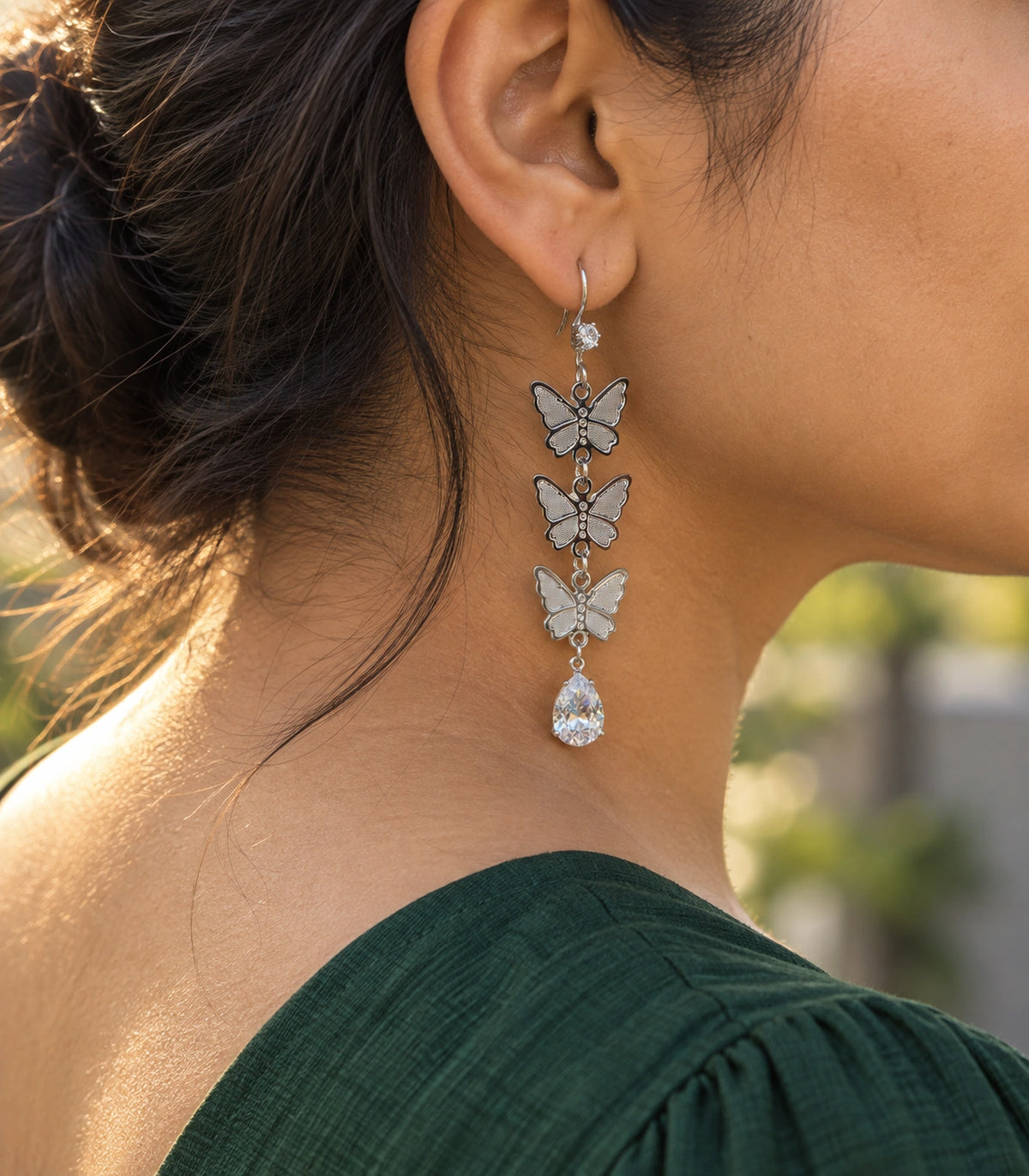 JIMIKI Silver Tone Three Butterfly Pear Drop Earring Pair in Silver-tone, editorial model view