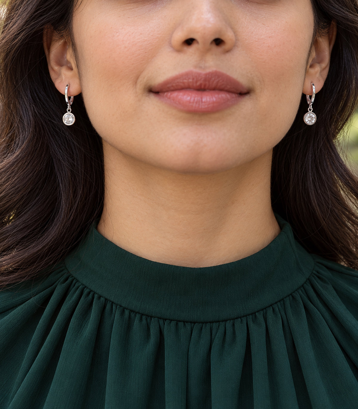 Silver-tone crystal hoop earrings in an editorial model view