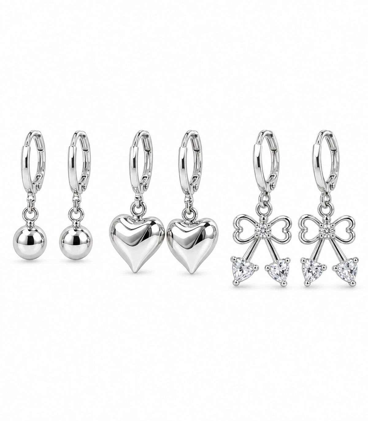 Complete silver-tone three-pair hoop earring set: ball, smooth heart and crystal bow pairs, six earrings on white