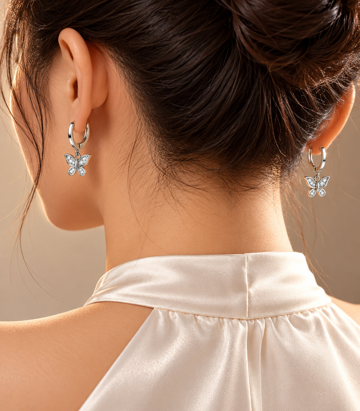 Silver Tone Three-Pair Crystal Butterfly Charm Hoop Earring Set — editorial-model showing one design from the set
