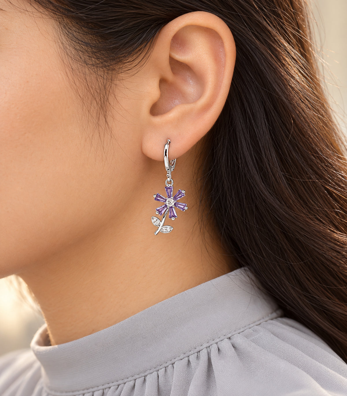 Editorial worn view of silver-tone hoop earrings from the three-pair set
