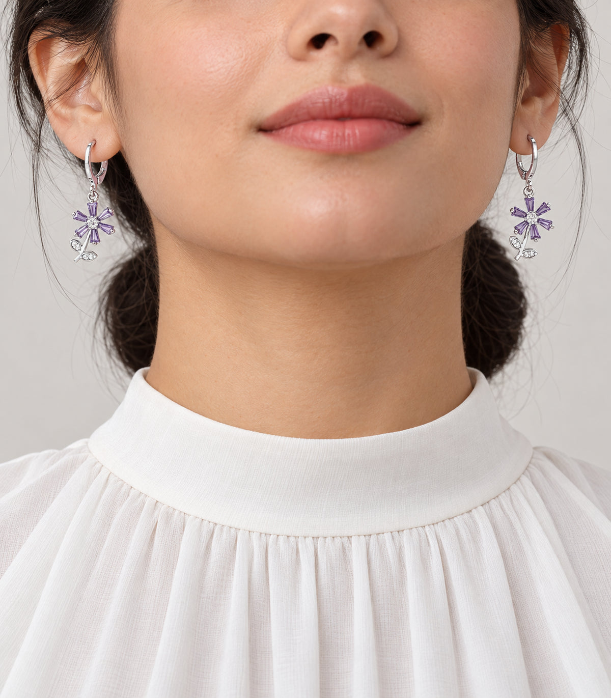 Silver-tone hoop earrings from the three-pair set shown worn