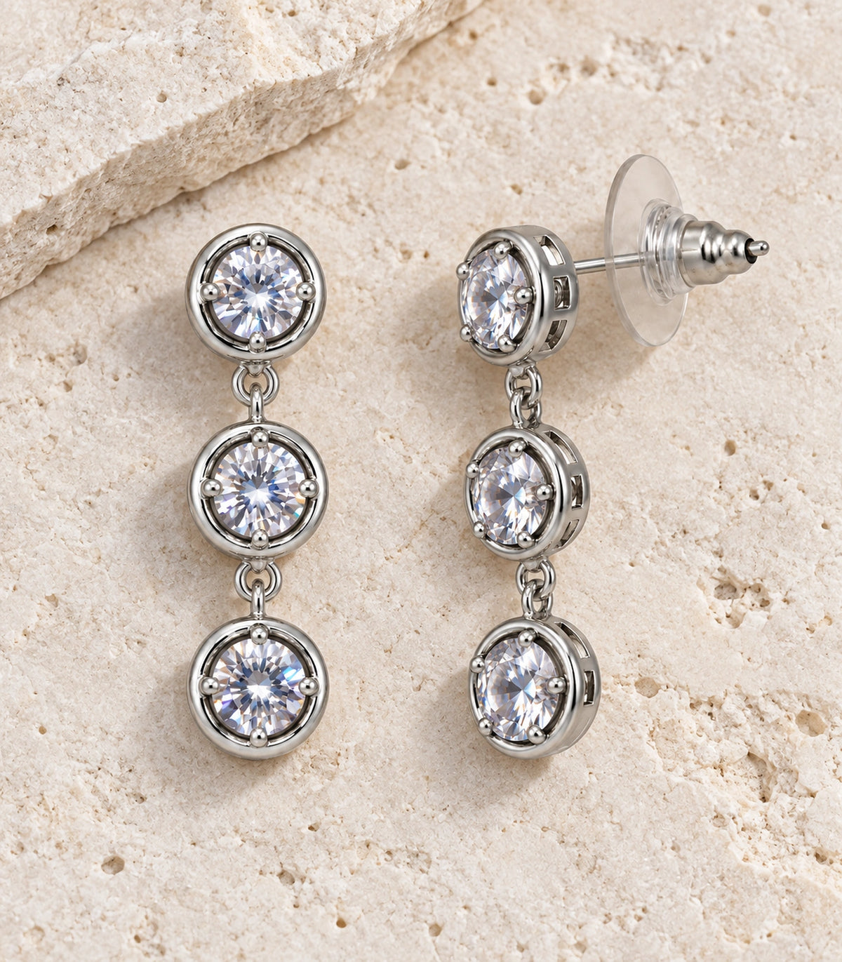 JIMIKI Three Round Crystal Drop Earring Pair in Silver tone/Clear, editorial flat lay #color_silver tone/clear