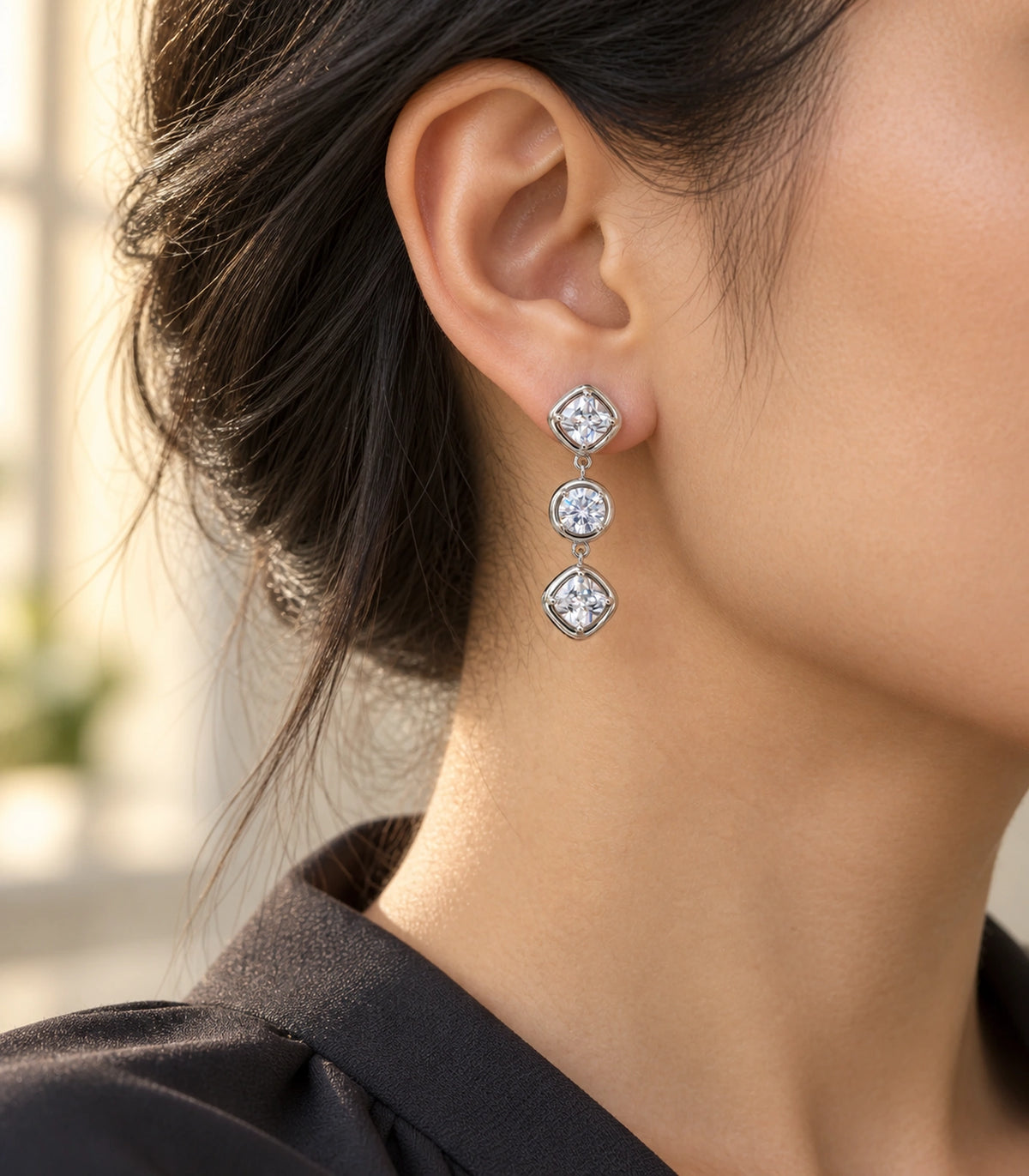 JIMIKI Three Stone Crystal Drop Earring Pair in Silver tone, editorial model view #color_silver tone