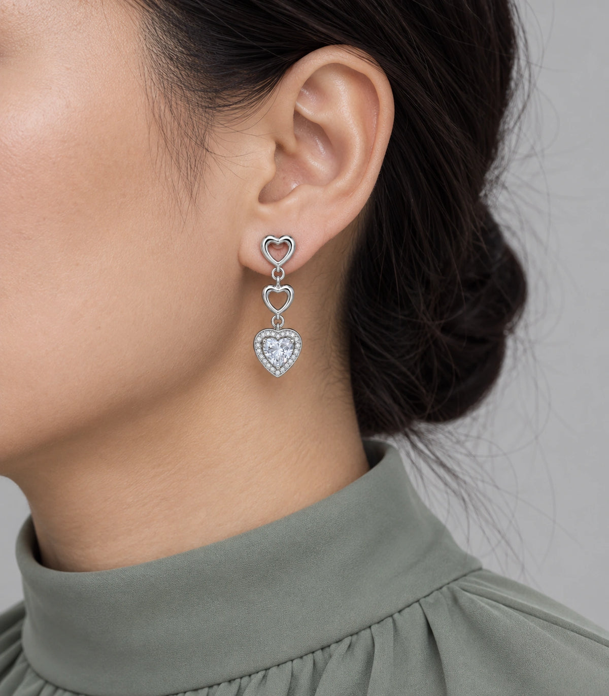 JIMIKI Triple Heart Crystal Drop Earring Pair in Silver tone / clear, model wearing view #color_silver tone / clear