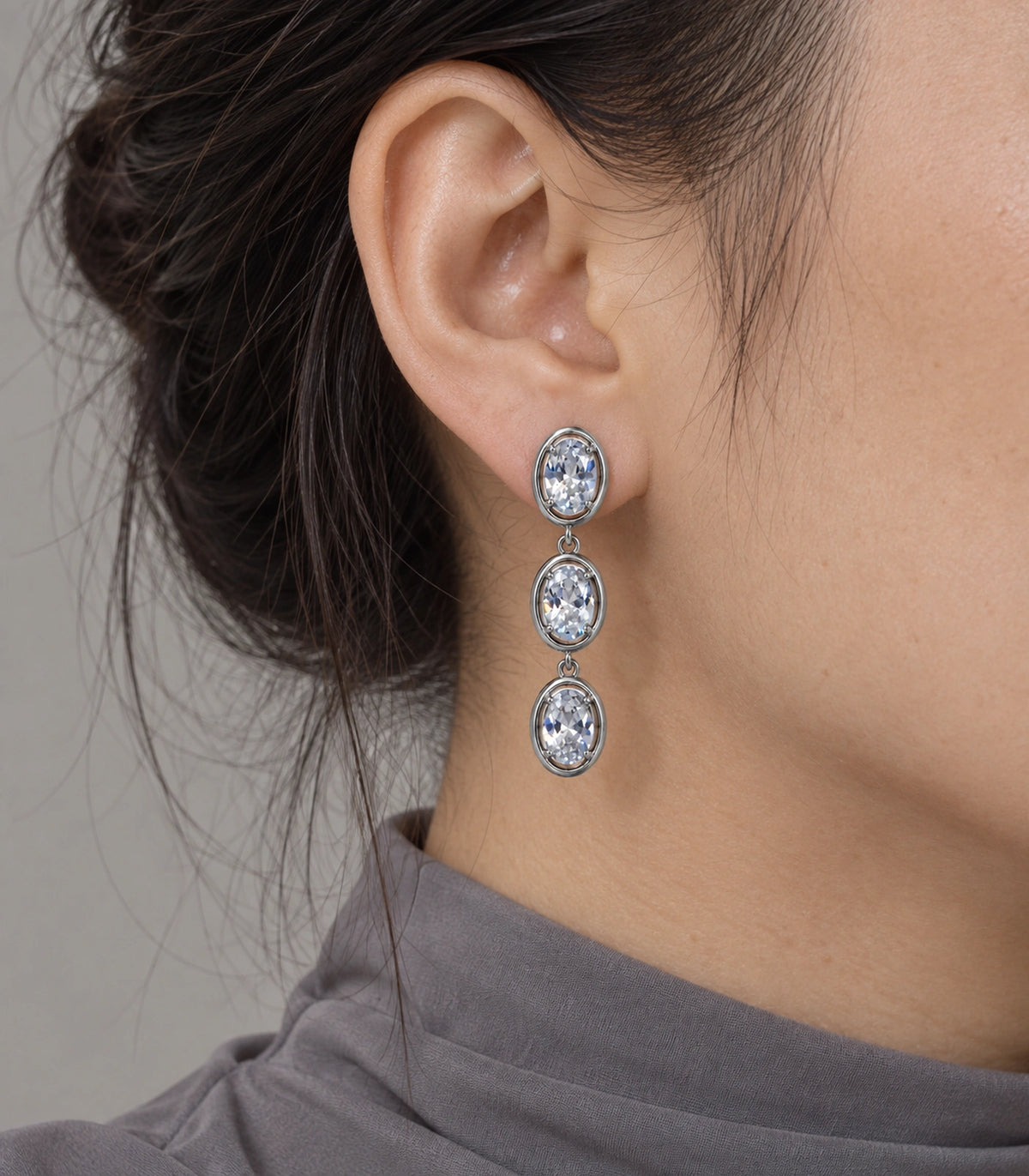 JIMIKI Triple Oval Crystal Drop Earring Pair in Silver tone, close-up detail #color_silver tone