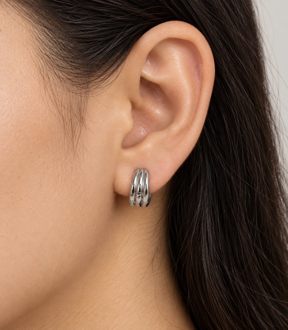 JIMIKI Triple-Ridge Huggie Hoop Earrings in Silver - model #color_silver