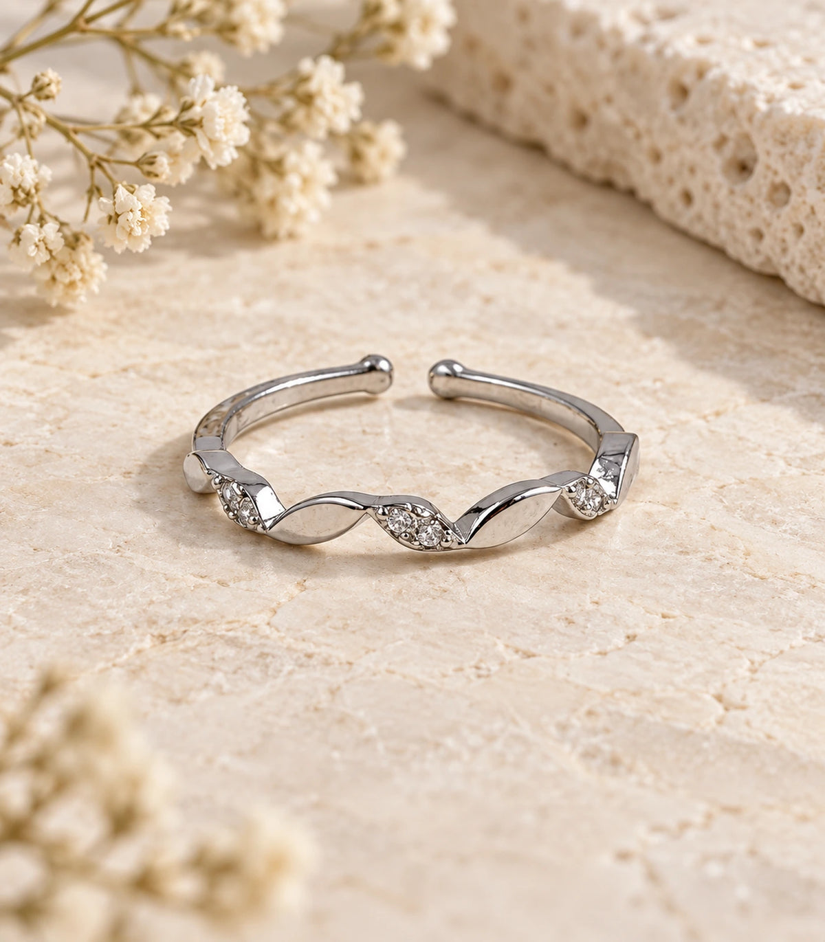 JIMIKI Twisted Leaf Crystal Adjustable Ring in Silver - editorial flatlay #color_silver