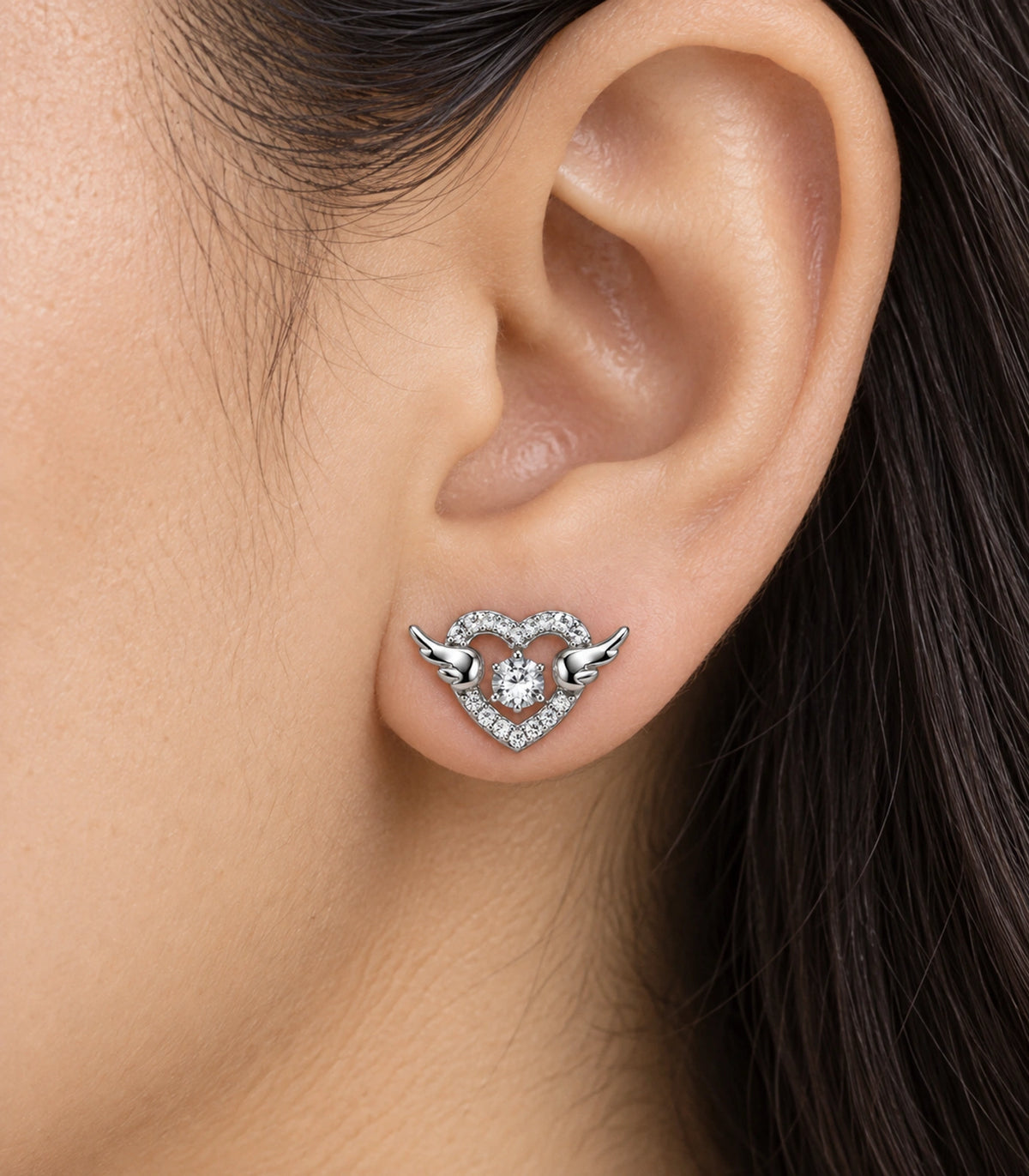 JIMIKI Winged Heart Crystal Stud Earrings in Silver — worn close-up detail #color_silver