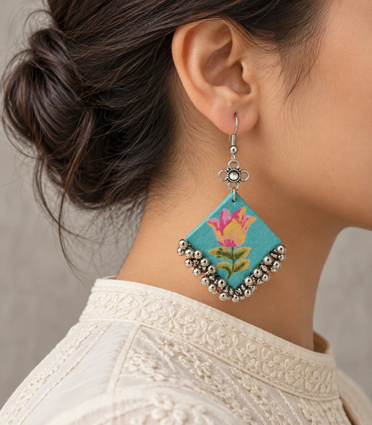Turquoise floral fabric ghungroo earring in an editorial worn view