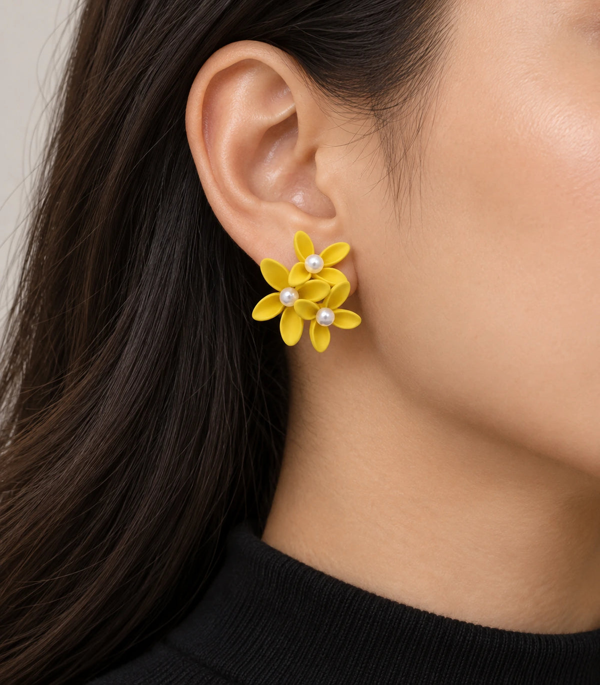 JIMIKI Yellow cascading floral cluster stud earrings, worn on the ear with the floral cluster visible #color_yellow
