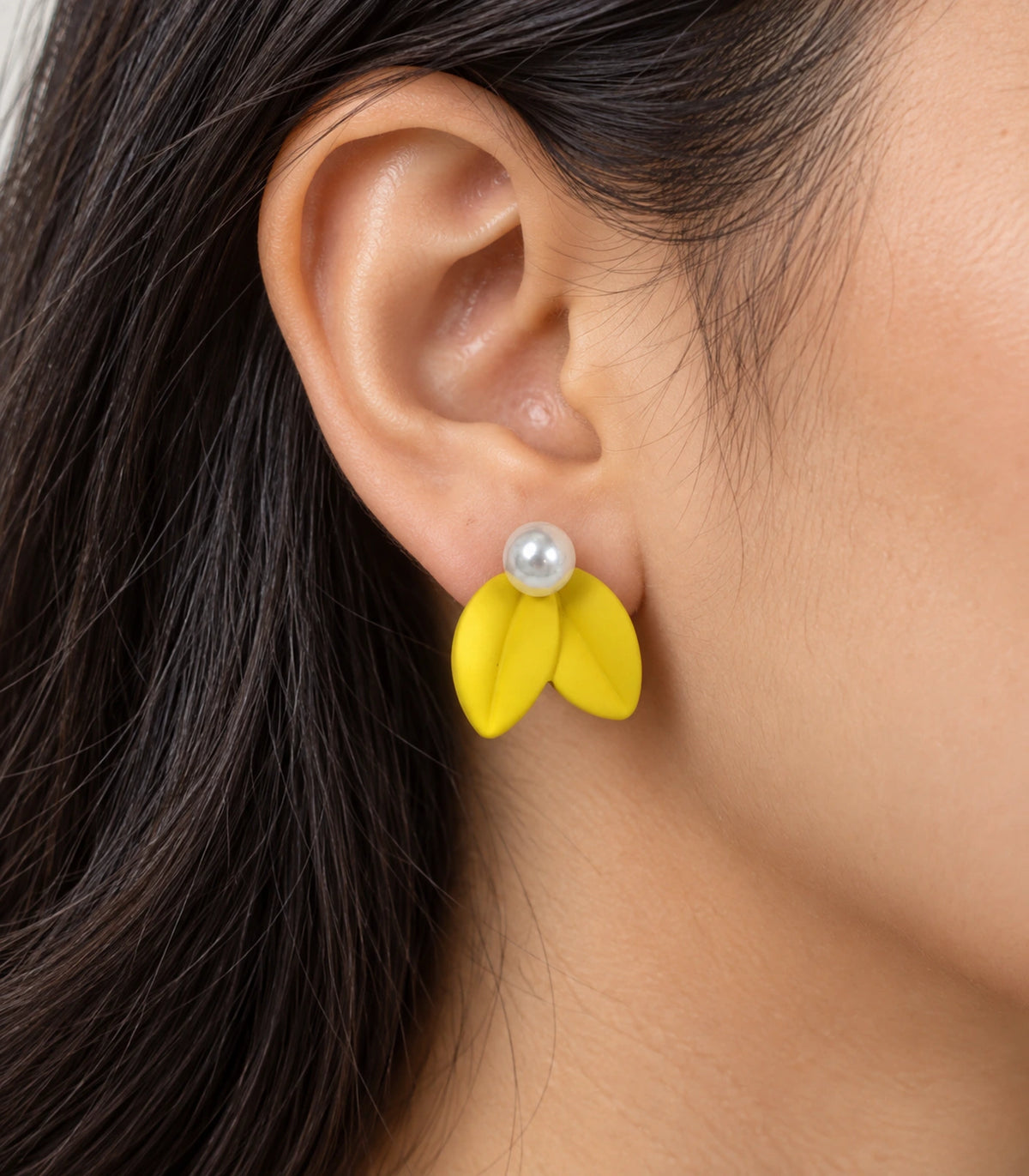 JIMIKI Double Leaf Pearl Stud Earrings in Yellow — close-up of the earring worn on the ear #color_yellow