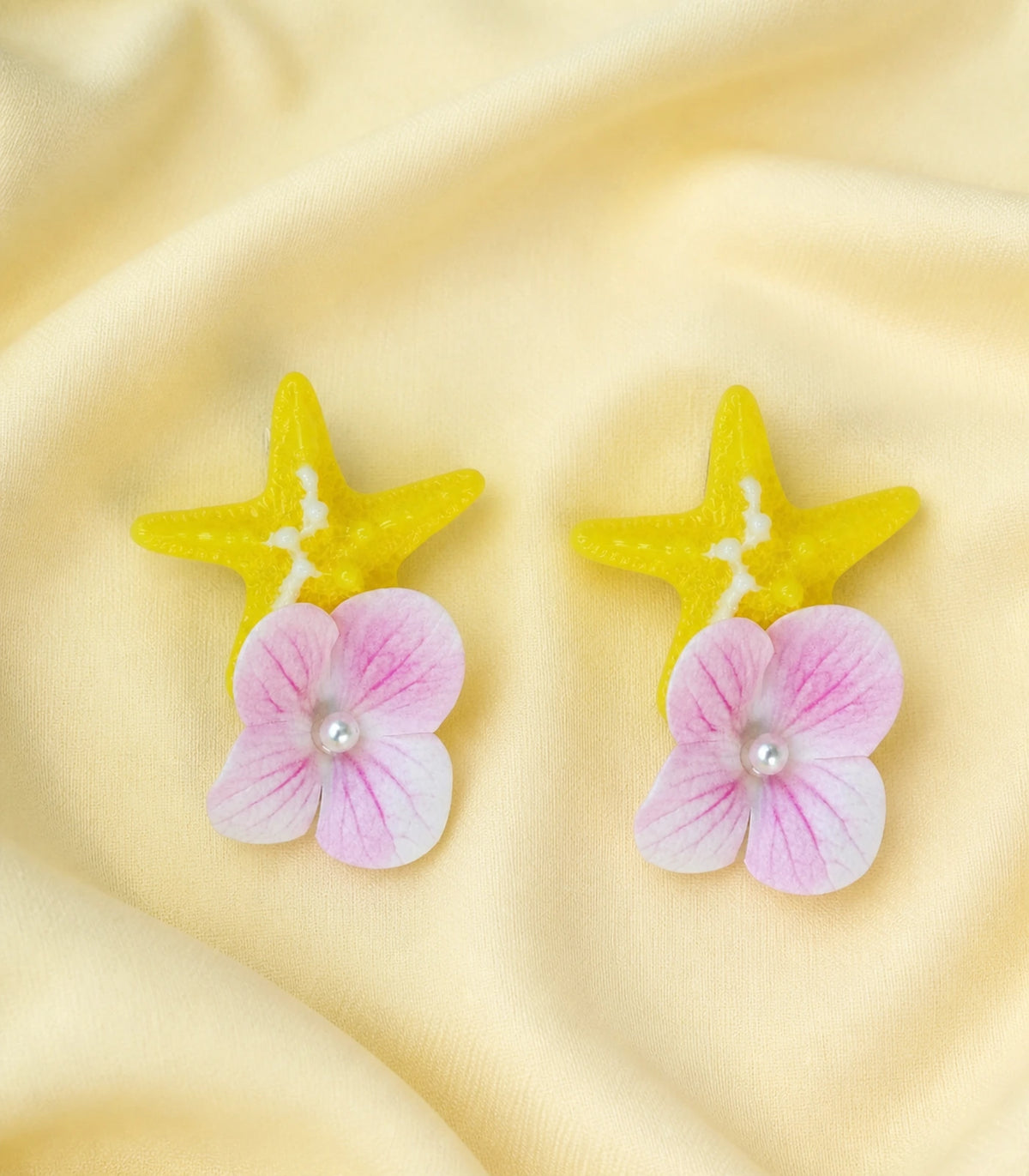 Editorial flat lay of the Yellow Starfish Pink Flower Clip Pair
